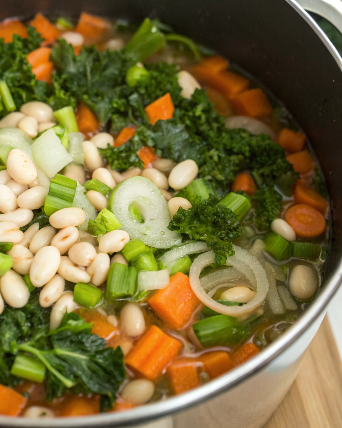 Step-by-step preparation of Kale & White Bean Soup in a pot on the stove.