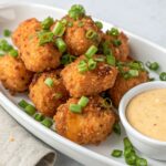 Crispy Bang Bang Chicken Bites served with a flavorful sauce