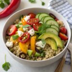 Bright and colorful healthy quinoa salad with mixed vegetables and herbs in a bowl, showcasing a nutritious dinner idea.