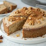 Warm Cinnamon Walnut Almond Flour Cake topped with walnuts and a sprinkle of cinnamon, showcasing a gluten-free, paleo dessert.