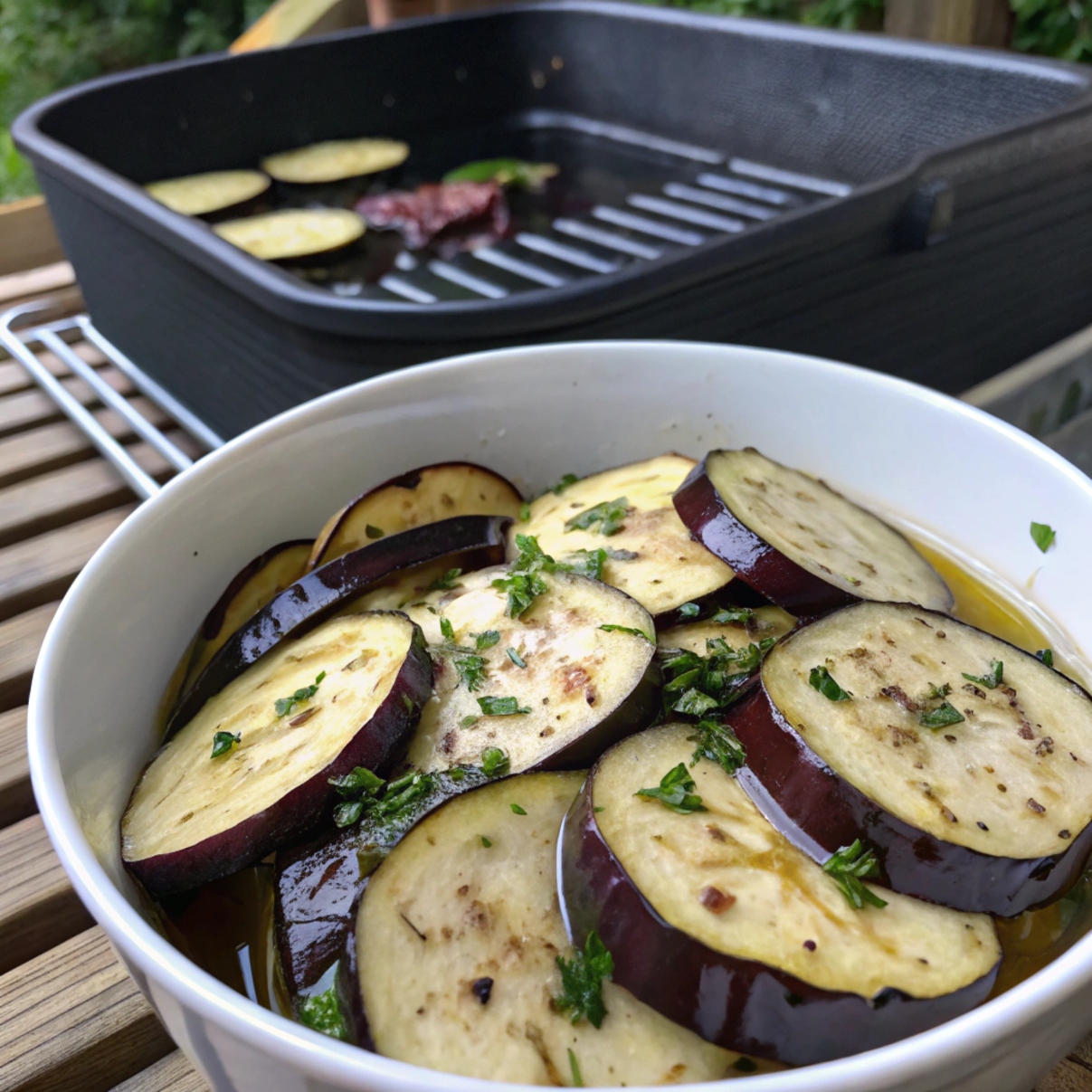 Sliced eggplant being seasoned and prepared for grilling, with salt and herbs on a cutting board