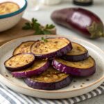 Golden-brown roasted eggplant pieces emerging from the oven with crispy edges.eggplant recipes