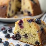 Close-up of the moist crumb and blueberries in gluten-free blueberry lemon cake