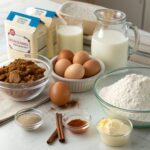 Assorted ingredients for cinnamon roll muffins, including flour, sugar, cinnamon, eggs, milk, and cream cheese.