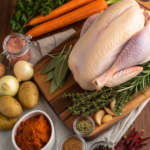 Fresh ingredients for Thanksgiving recipes, including turkey, herbs, vegetables, and spices.