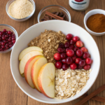 Ingredients for Apple Cranberry Crisp including apples, cranberries, oats, and spices