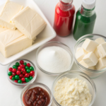 Ingredients for Christmas Swirl No-Bake Cheesecake including cream cheese, sugar, heavy cream, and food coloring