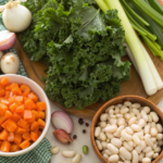 Fresh ingredients for Kale & White Bean Soup, including kale, white beans, vegetables, and herbs.