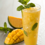 Tropical Mango Mocktail with vibrant mango puree and mint leaves - Virgin Summer Drinks.